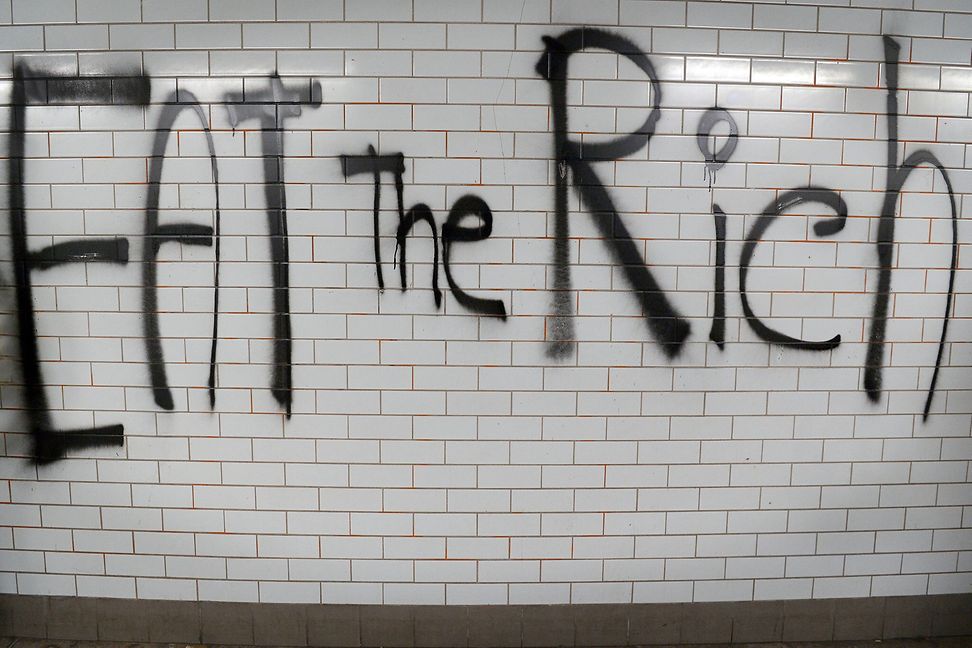 Graffiti in the London tube. The slogan "eat the rich" is attributed to French philosopher Jean-Jacques Rousseau.