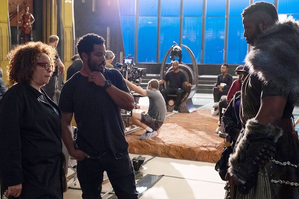 Carter and director Coogler look critically at an actor on the filming set of Black Panther