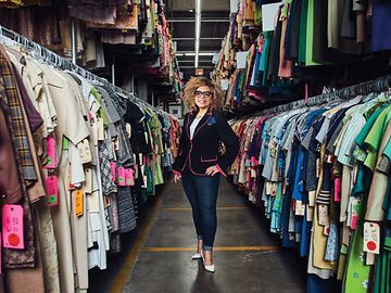Ruth Carter in front of many clothes