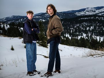 Two teenagers facing the camera in snowy Montana