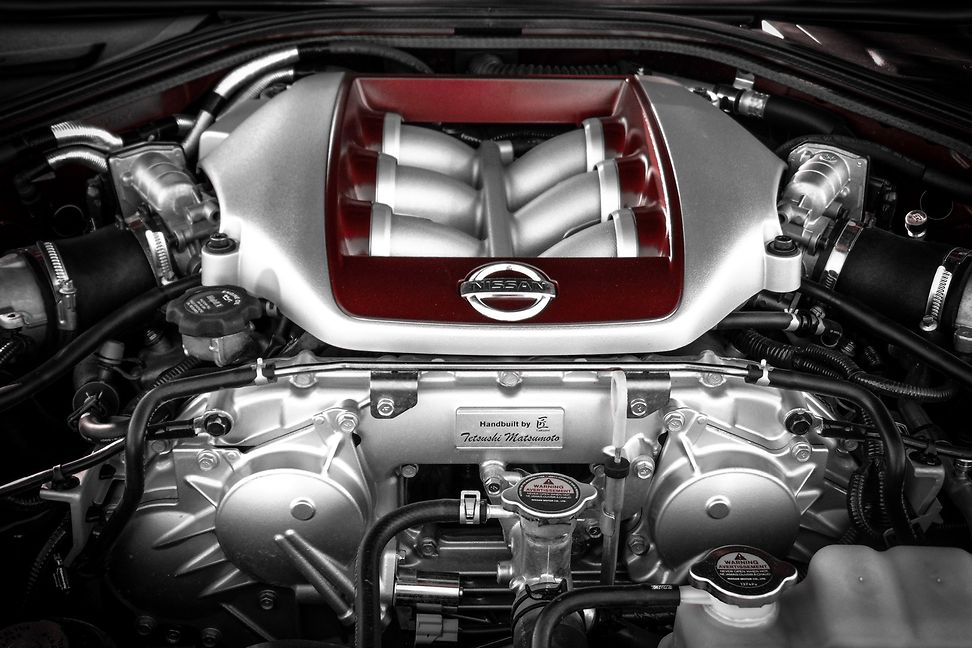 close-up under the hood of a Nissan engine