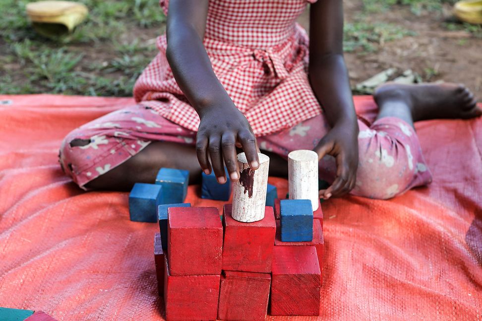 Child playing with colourful blocks