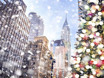 A snowy Christmas street in Manhattan with the Chrysler Building in the distance