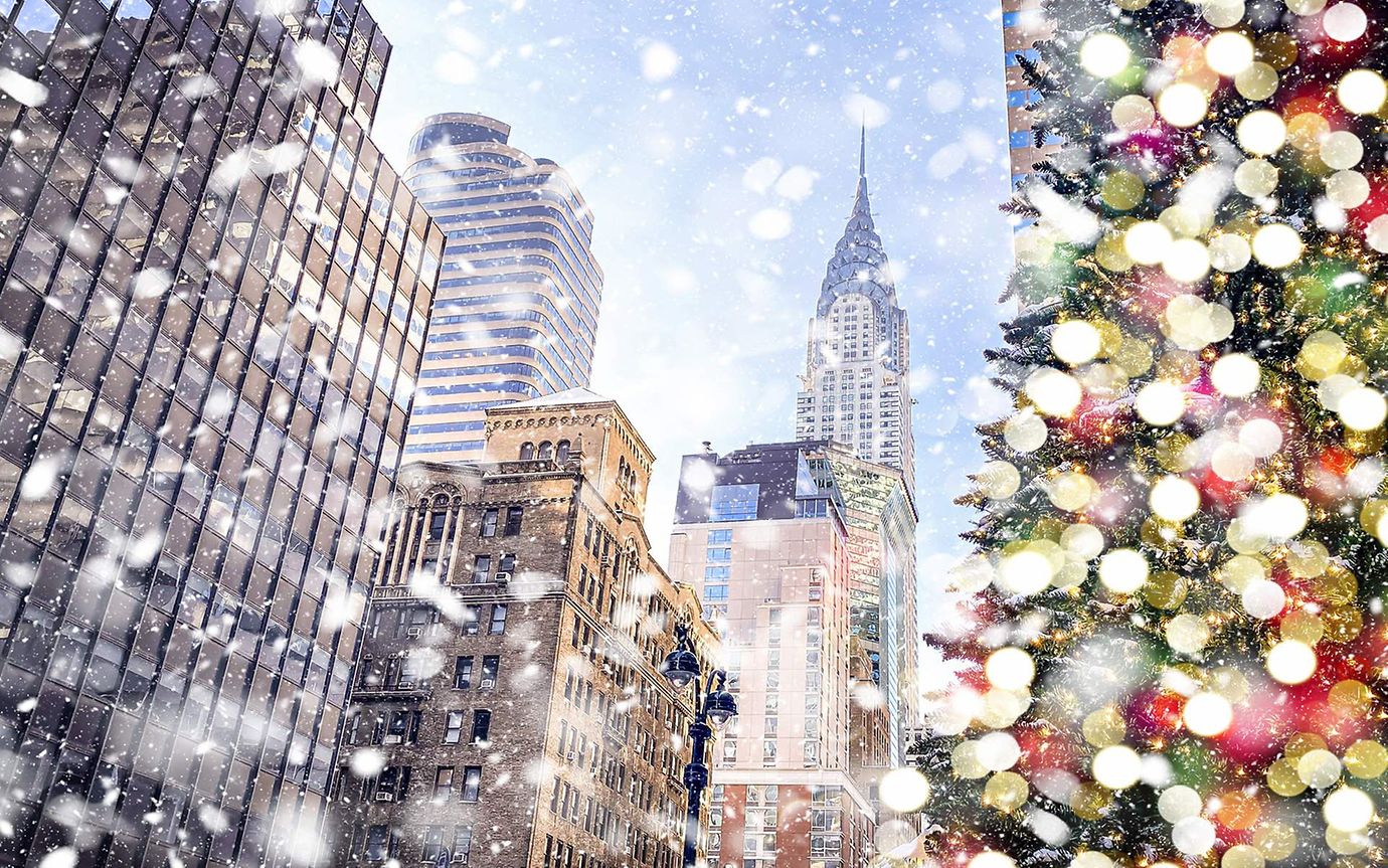 A snowy Christmas street in Manhattan with the Chrysler Building in the distance