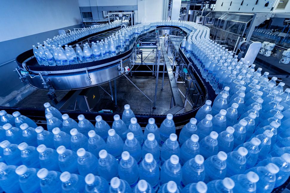 Conveyor of drinking water bottles in a modern drinks factory 