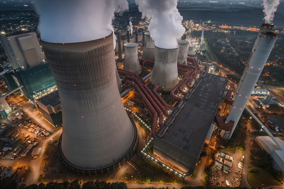 Bird's eye view of a coal-fired power station in an industrial area at night.