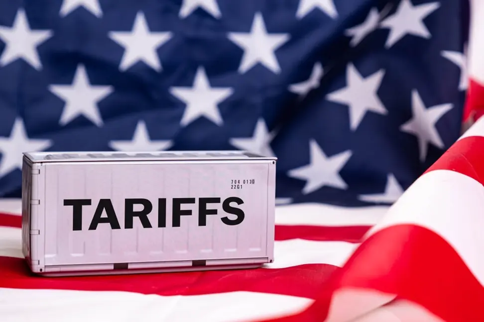The word tariffs with an American flag