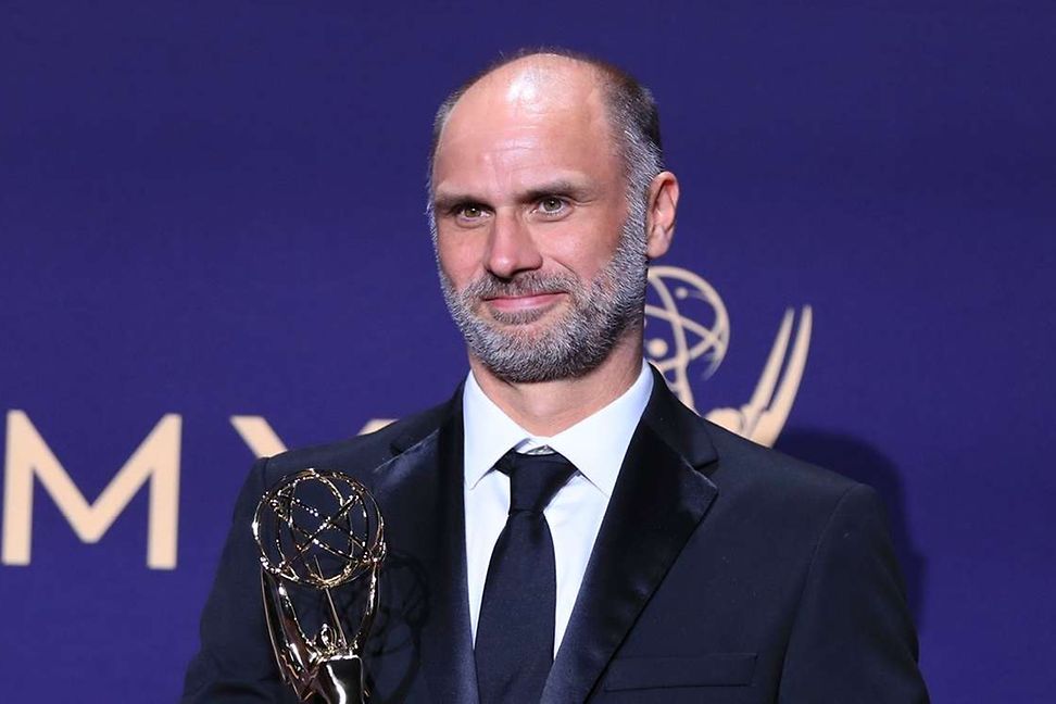 Jesse Armstrong poses with an EMMY for Outstanding Writing for a Drama Series for